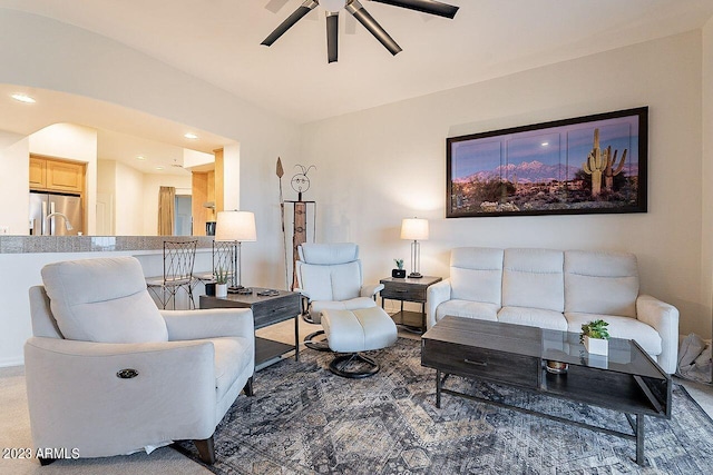 living room featuring carpet and ceiling fan