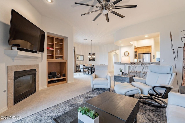 living room with carpet, built in features, and ceiling fan