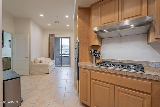 kitchen featuring light tile patterned flooring, extractor fan, and stainless steel gas cooktop