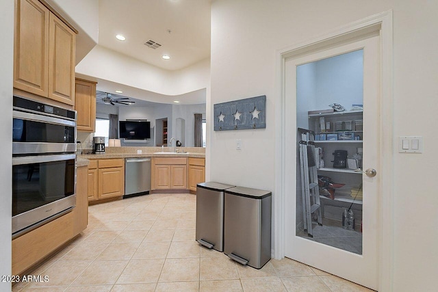 kitchen featuring sink, ceiling fan, light tile patterned floors, light brown cabinetry, and stainless steel appliances