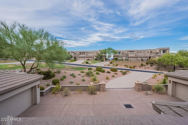 view of property's community with a garage