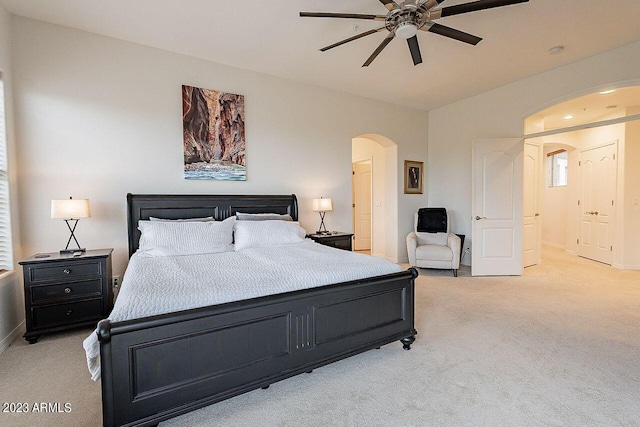 bedroom with ceiling fan and light carpet