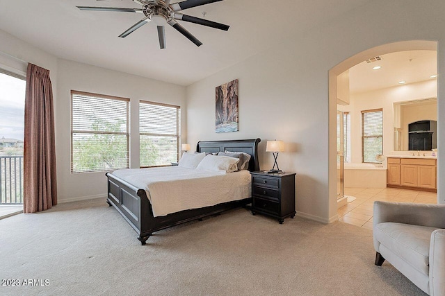 carpeted bedroom with access to outside, connected bathroom, ceiling fan, and sink