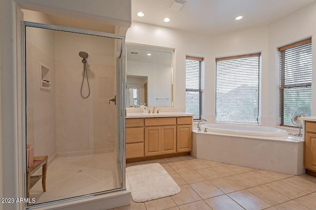 bathroom with plus walk in shower, vanity, and tile patterned floors