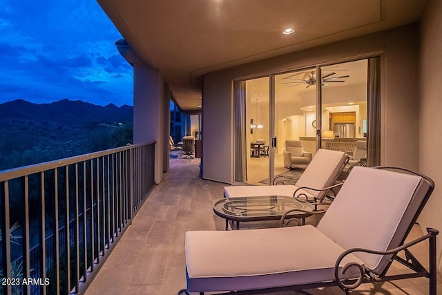 balcony at dusk featuring a mountain view