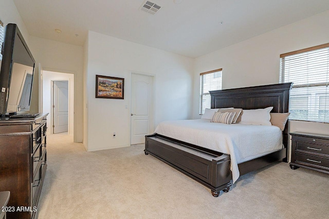 carpeted bedroom with multiple windows