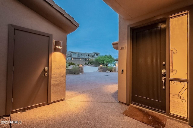 view of exterior entry featuring a patio