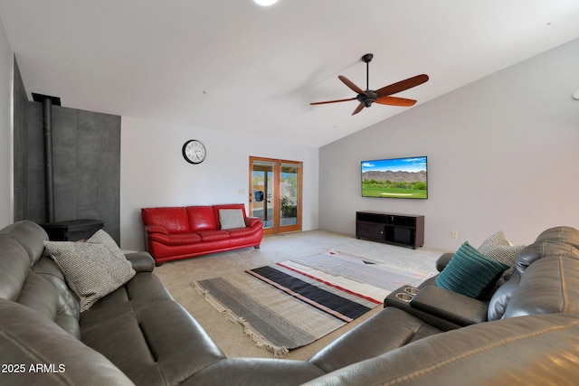 carpeted living room featuring ceiling fan, vaulted ceiling, and french doors