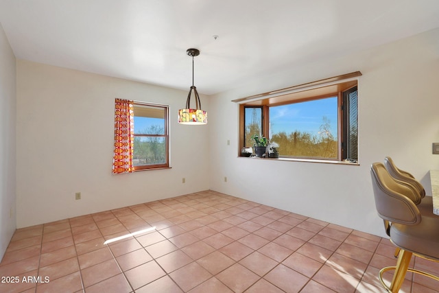 unfurnished dining area featuring light tile patterned floors