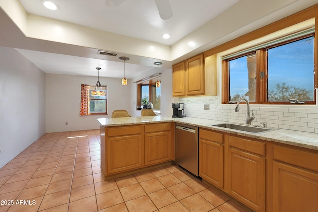 kitchen with dishwasher, sink, tasteful backsplash, kitchen peninsula, and decorative light fixtures