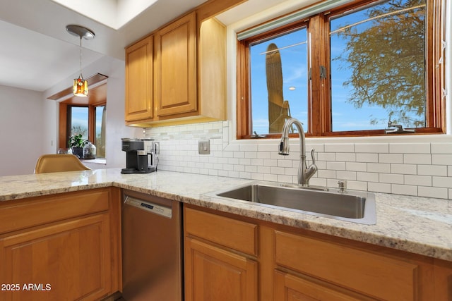 kitchen featuring decorative backsplash, light stone countertops, sink, decorative light fixtures, and dishwasher