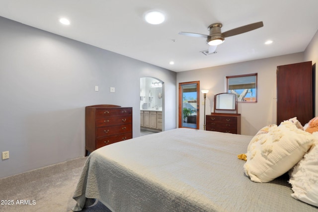 carpeted bedroom featuring connected bathroom and ceiling fan