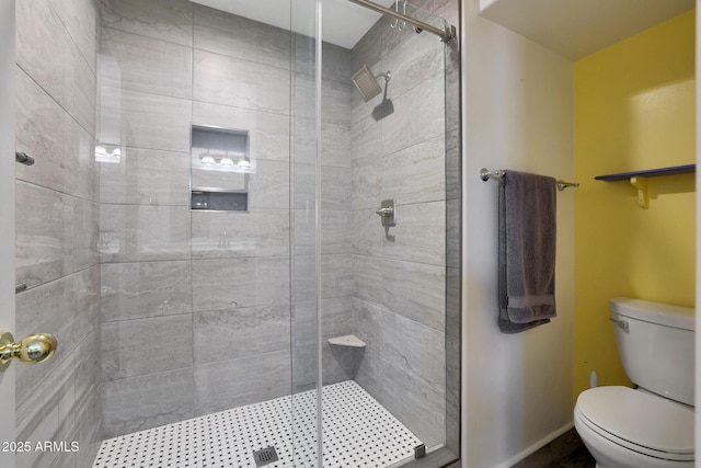 bathroom with a shower with door and toilet