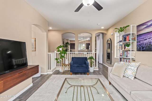 living area with recessed lighting, ceiling fan, baseboards, and wood finished floors