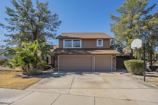 traditional-style home with a garage, driveway, brick siding, and stucco siding