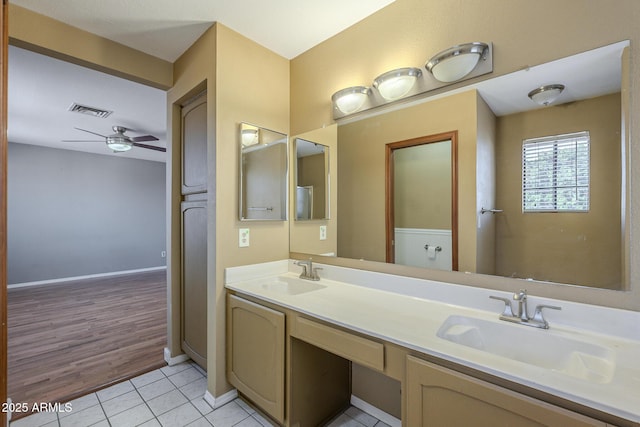 full bath with tile patterned flooring, visible vents, ceiling fan, and a sink