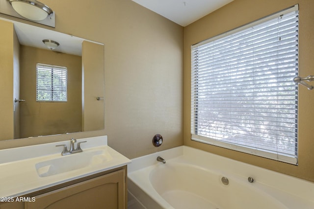 bathroom featuring a garden tub and vanity