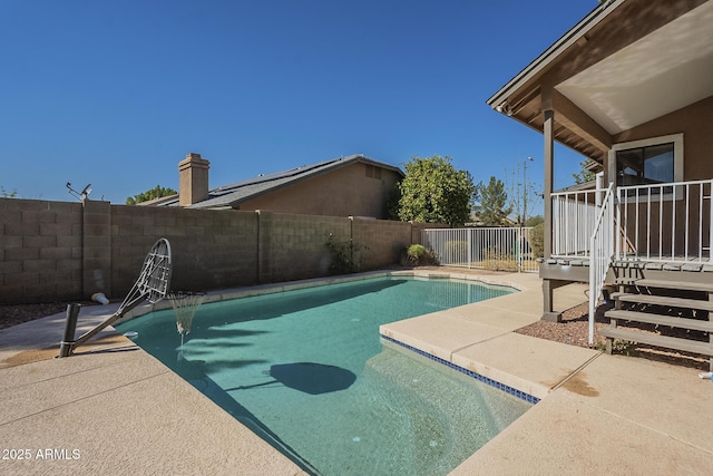 view of swimming pool featuring a fenced in pool, a fenced backyard, and a patio