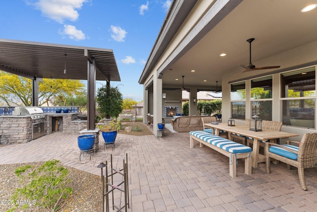view of patio / terrace featuring area for grilling, outdoor dining area, and a ceiling fan