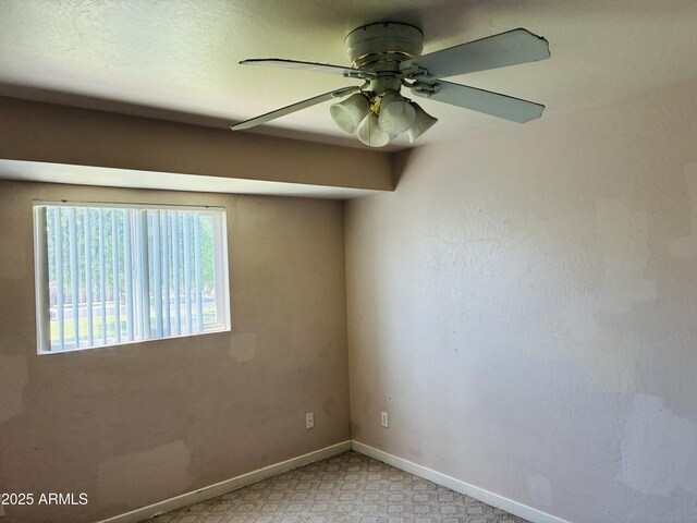 empty room with baseboards and ceiling fan