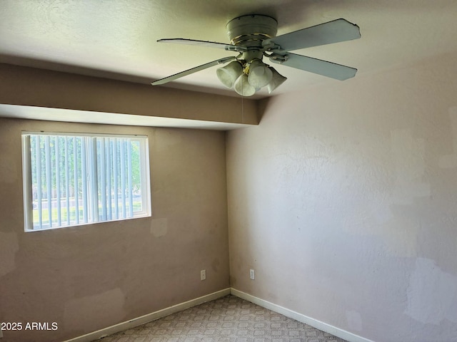 empty room with baseboards and ceiling fan
