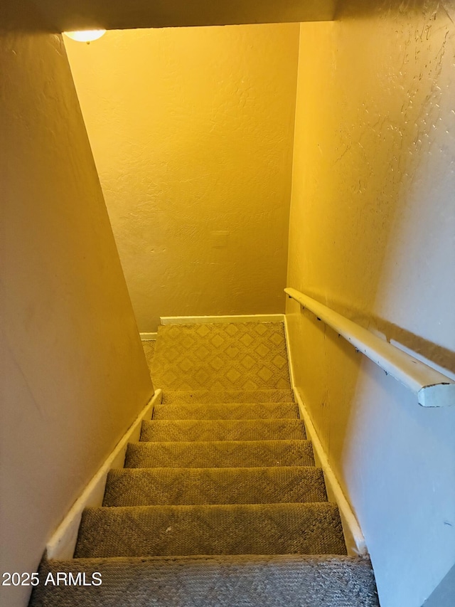 stairway featuring baseboards