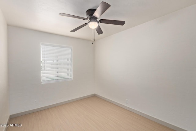 empty room with baseboards, ceiling fan, and light wood finished floors