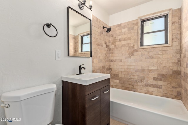 bathroom with tub / shower combination, toilet, and vanity