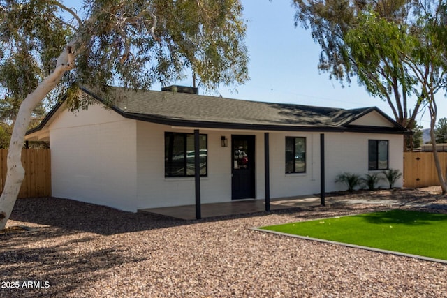 single story home featuring fence