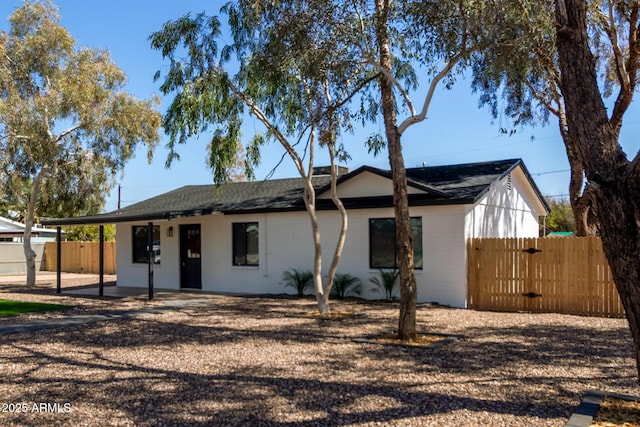 view of front of property featuring a gate, a patio area, and fence