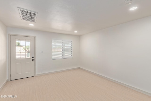 unfurnished room with recessed lighting, visible vents, baseboards, and wood finished floors