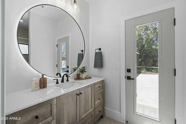 bathroom with baseboards and vanity