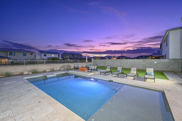 pool at dusk featuring outdoor lounge area and a patio