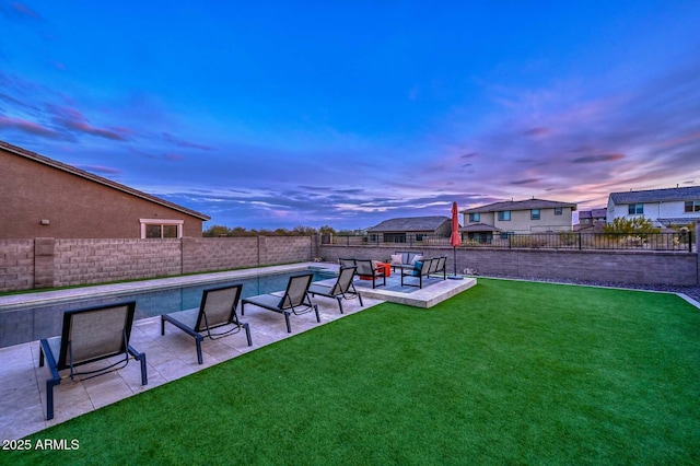 yard at dusk featuring a patio area