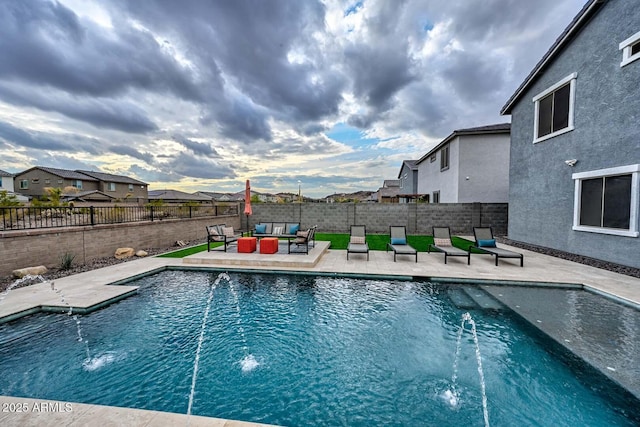 view of swimming pool featuring pool water feature, outdoor lounge area, and a patio area