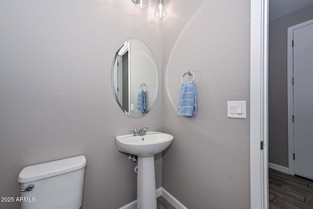 bathroom with wood-type flooring and toilet