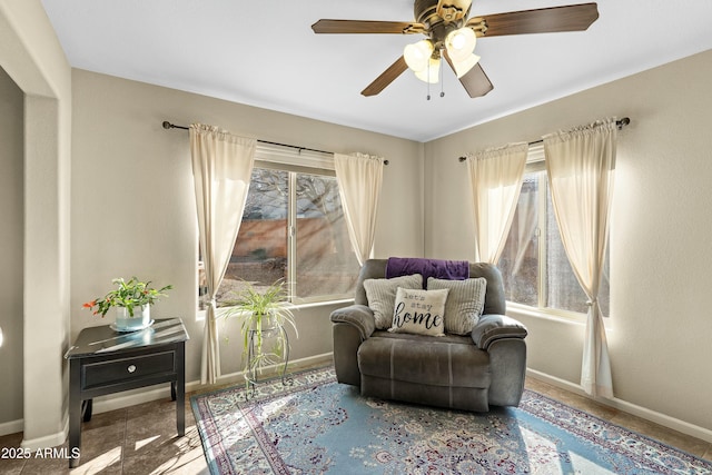 living area with ceiling fan