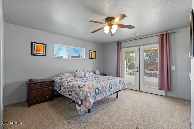 carpeted bedroom with a textured ceiling, ceiling fan, french doors, and access to outside