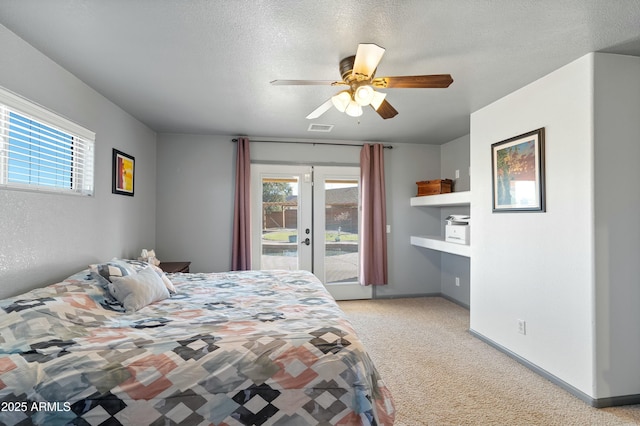 bedroom with ceiling fan, light colored carpet, access to outside, a textured ceiling, and french doors