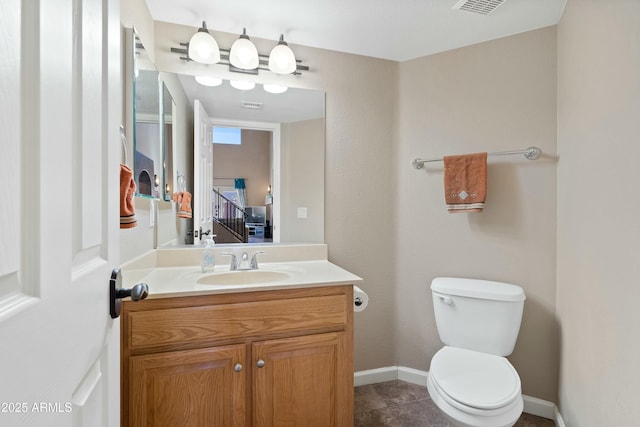 bathroom with toilet and vanity