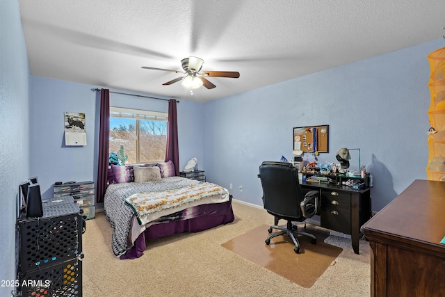 bedroom with a textured ceiling, ceiling fan, and light carpet