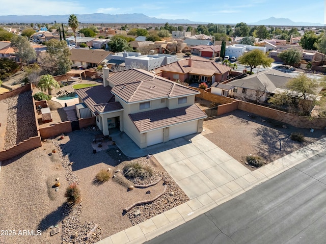 birds eye view of property with a mountain view