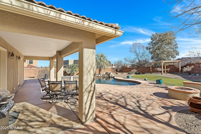 view of patio with a fenced in pool and a fire pit