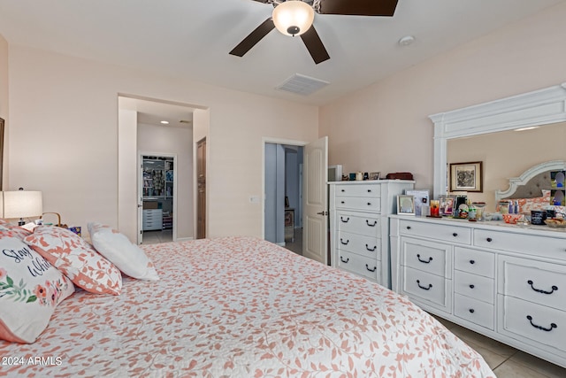 tiled bedroom with ceiling fan