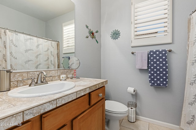 bathroom featuring vanity, toilet, and tile patterned floors