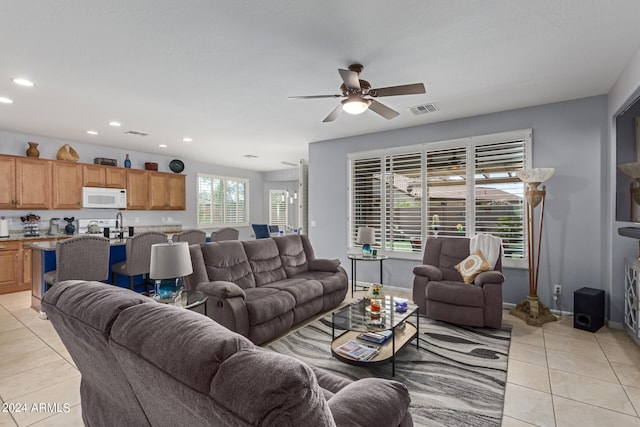 tiled living room with ceiling fan