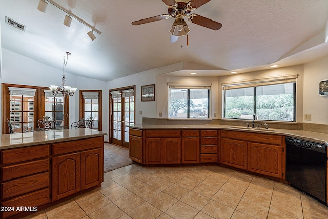 kitchen featuring dishwasher, sink, hanging light fixtures, lofted ceiling, and light tile patterned flooring