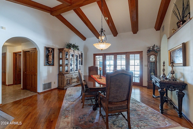 13108 N 76th St, Scottsdale, AZ 85260 - dining space featuring arched walkways, french doors, beam ceiling, high vaulted ceiling, and wood finished floors