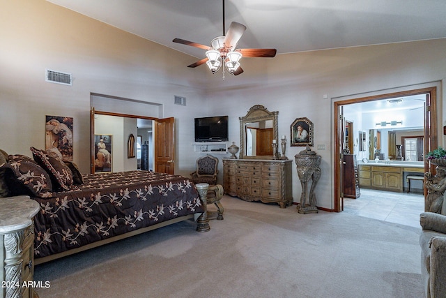 carpeted bedroom with a closet, ensuite bath, ceiling fan, and lofted ceiling