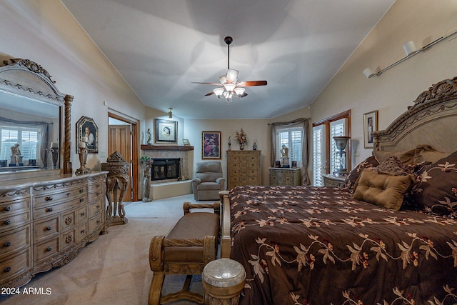 carpeted bedroom with ceiling fan and vaulted ceiling